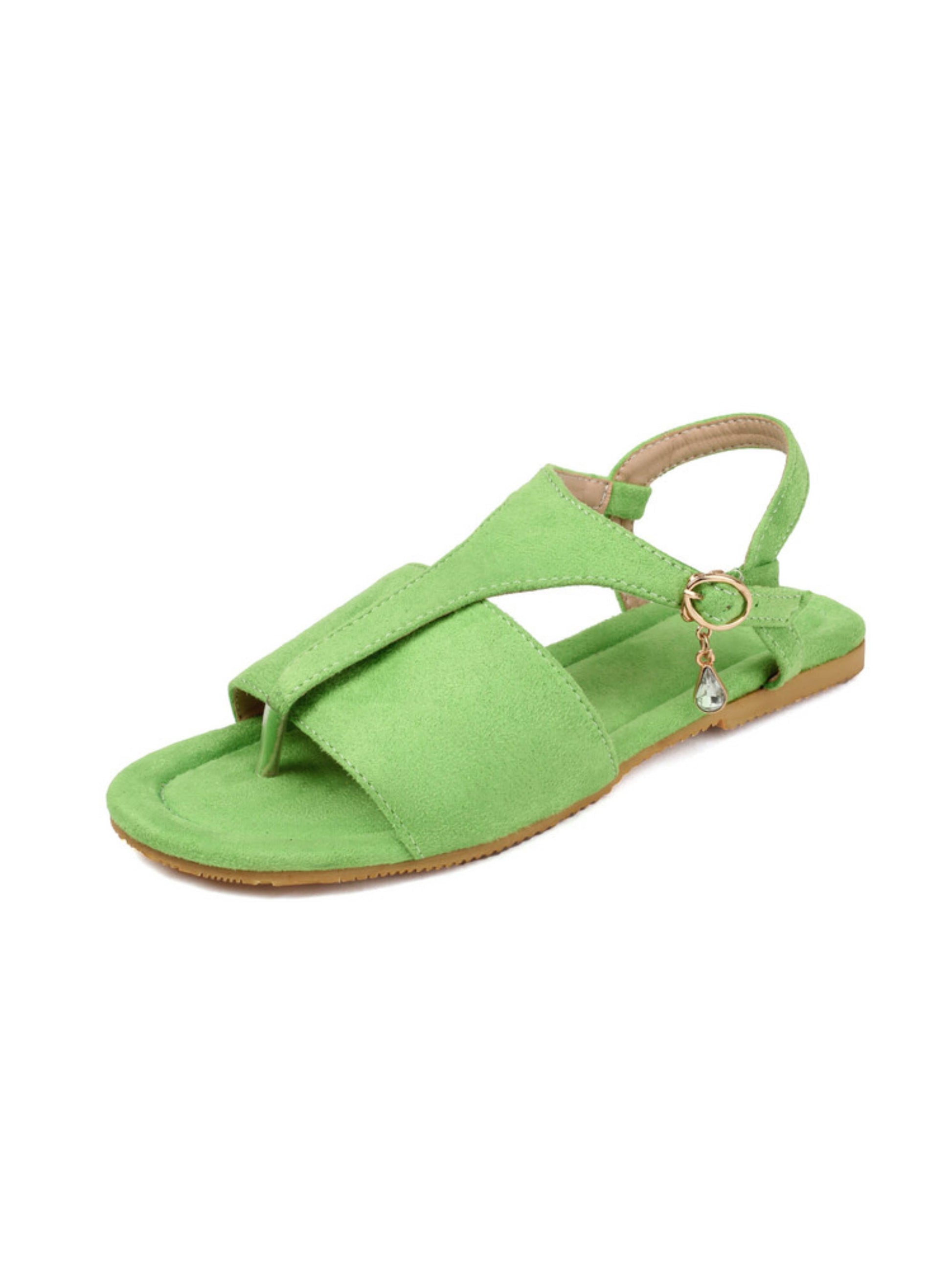 Green sandal with a decorative charm