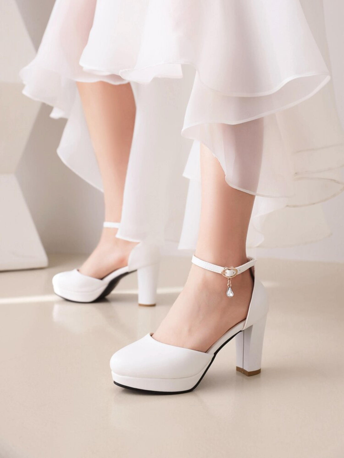 White high-heeled shoe with clear panels