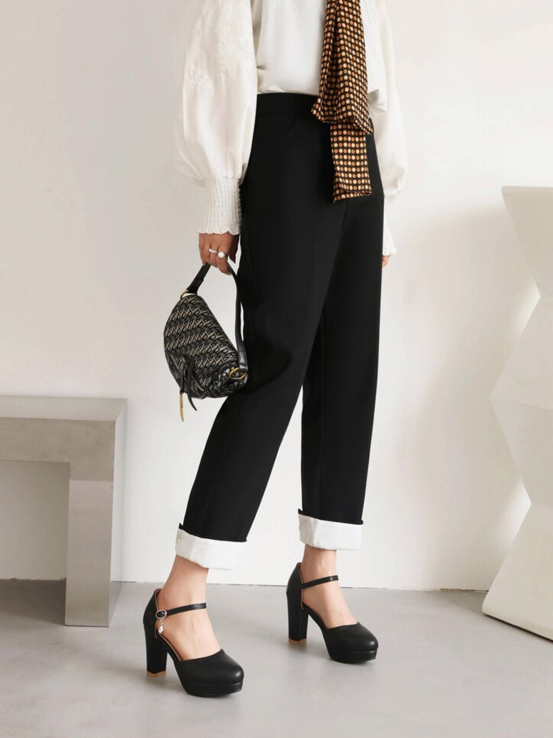 Black high-heeled shoe with a platform