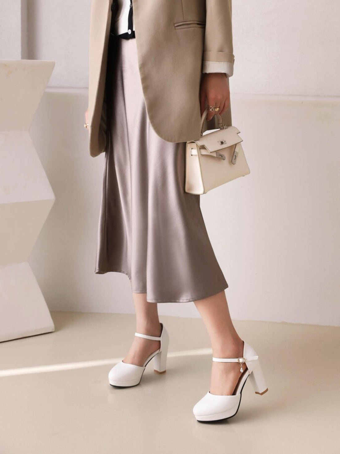 White high-heeled shoe with a strap